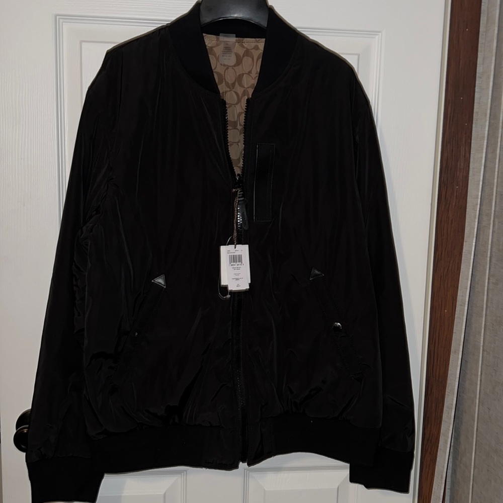 Black and tan Coach jacket